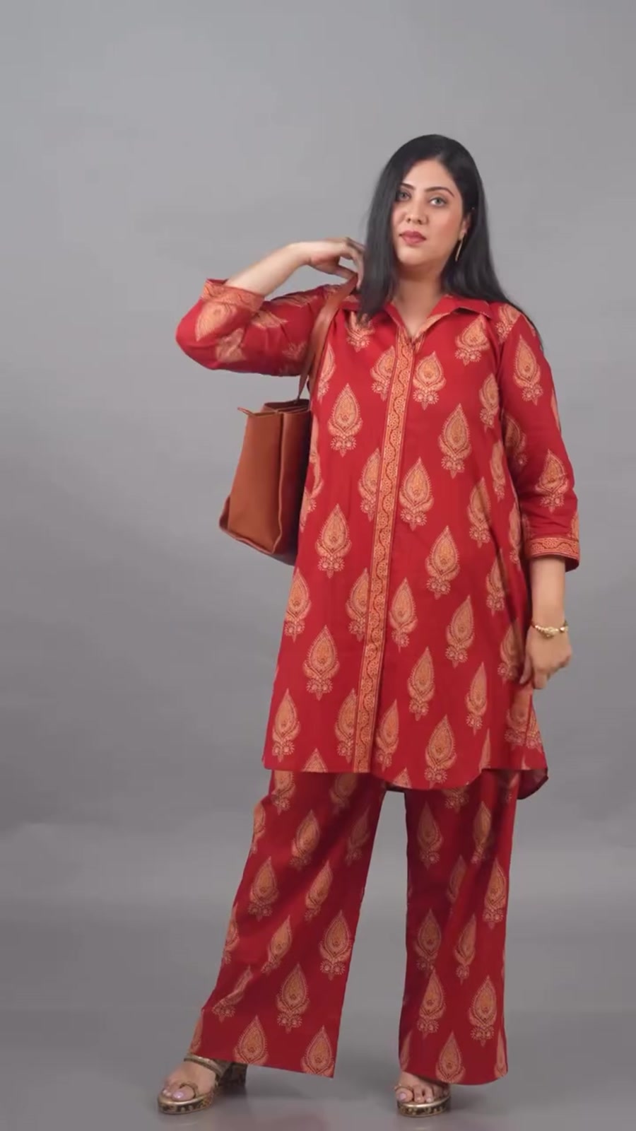 The Ammu co-ord set in red block print, worn with a tan tote