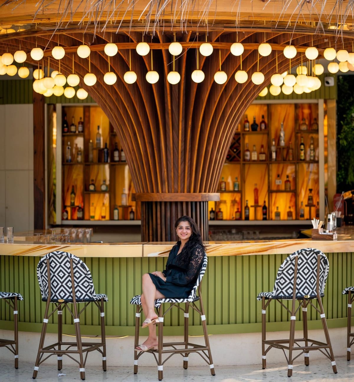 The Kiki bar under its glowing rattan chandelier