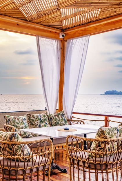 A curtained cabana table looking out to sea