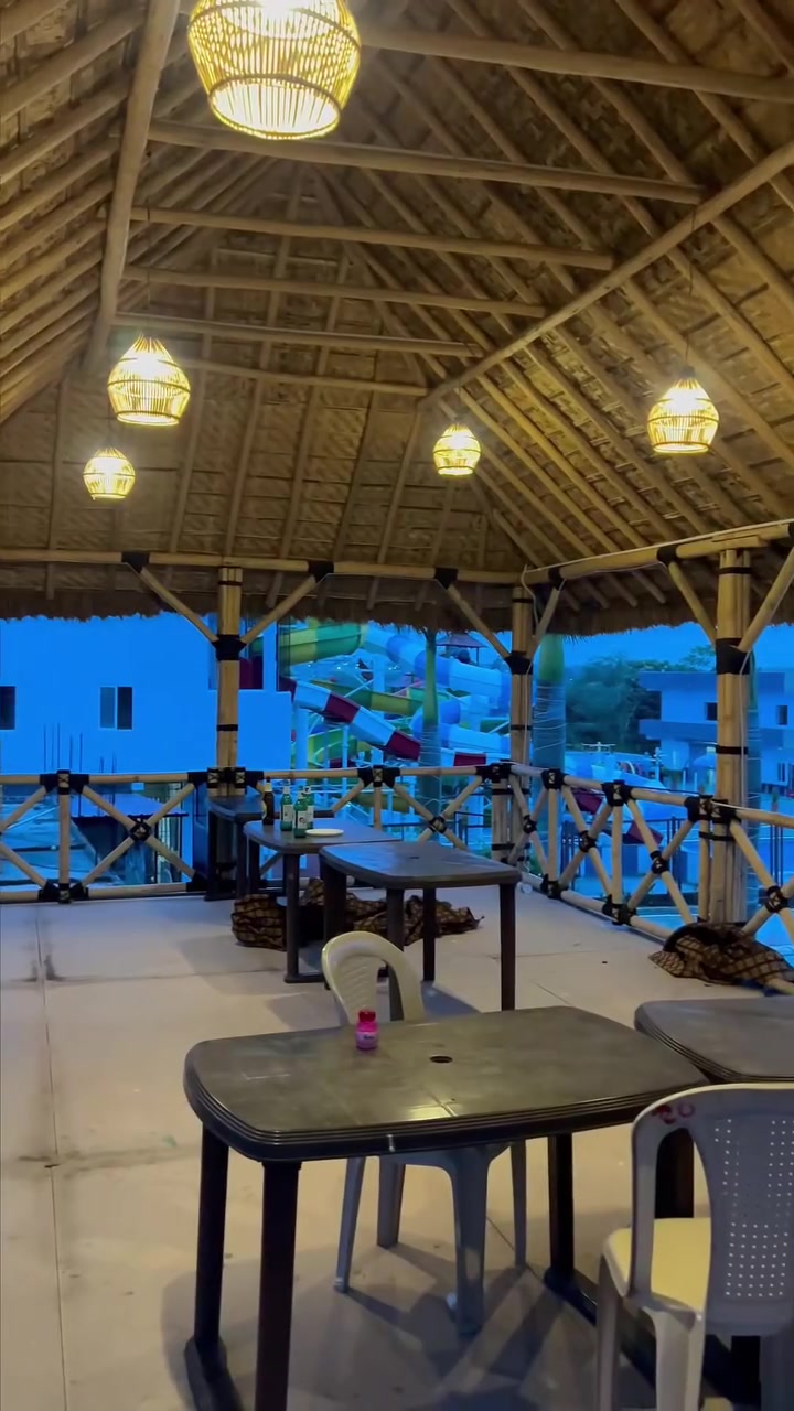 The thatched poolside cabana with lanterns