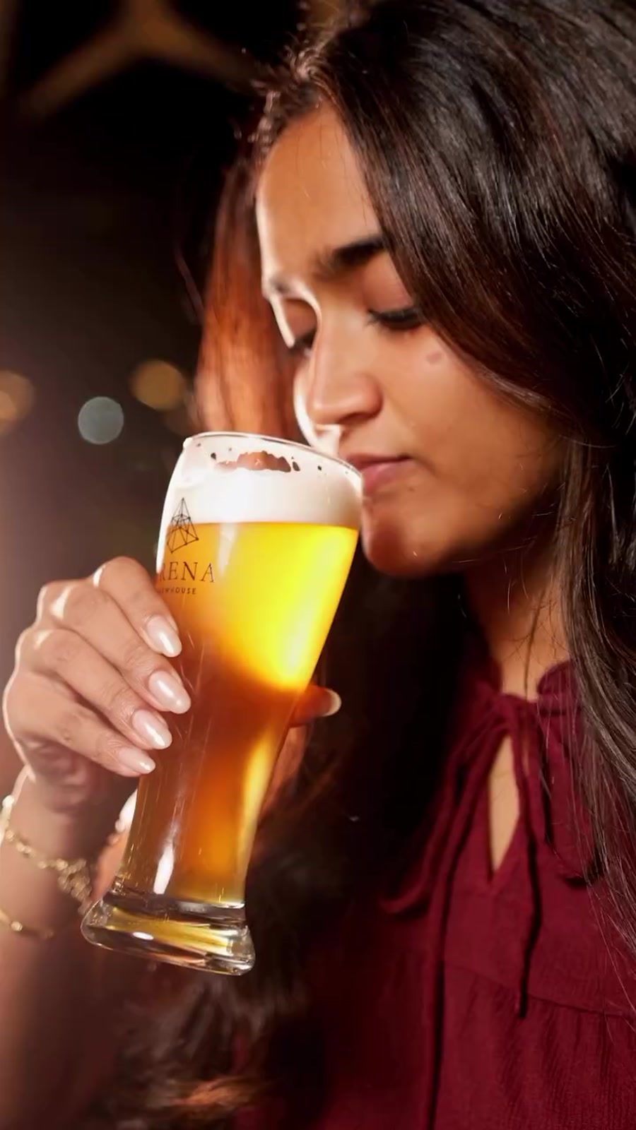 A guest with a fresh pint of Arena beer