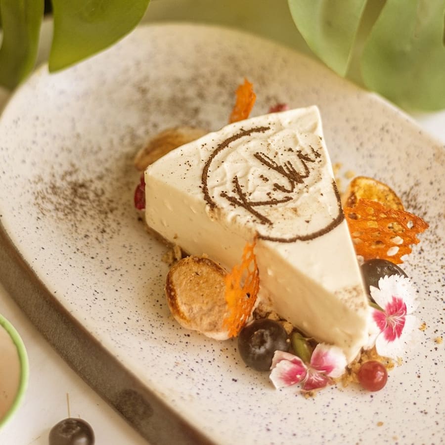 Kiki's signature cheesecake with a chocolate Kiki disc