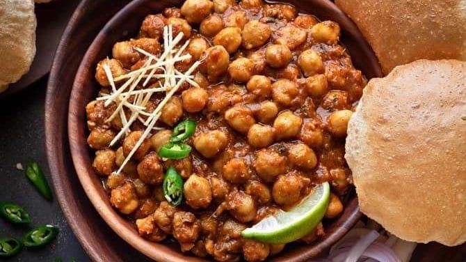 Chole bhature with sliced onions and chilli