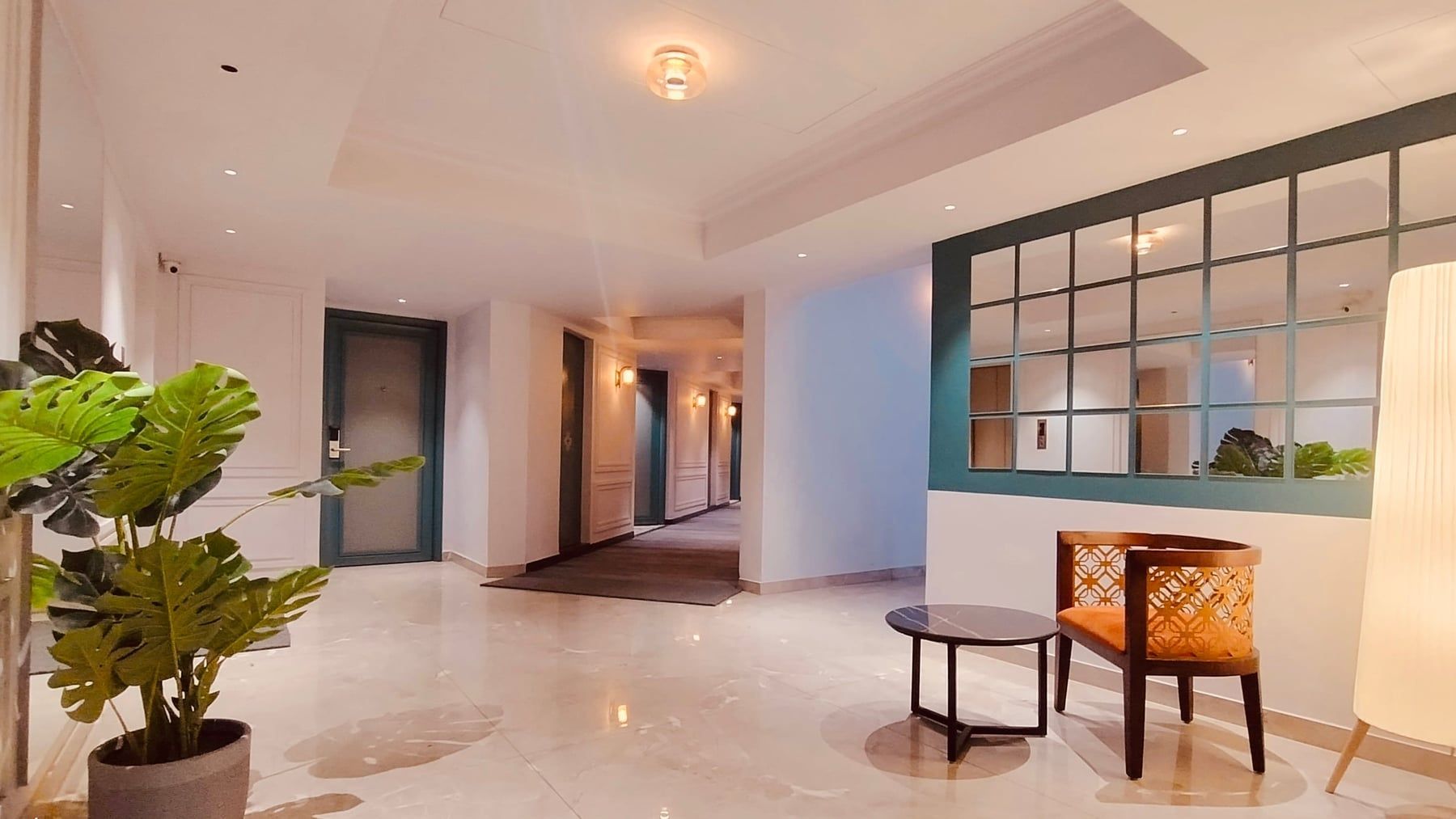 Long lamp-lit guest corridor