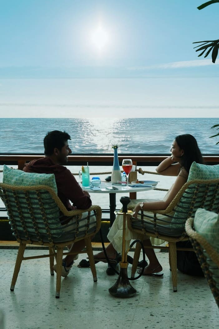 Guests at a sea-view table at sunset