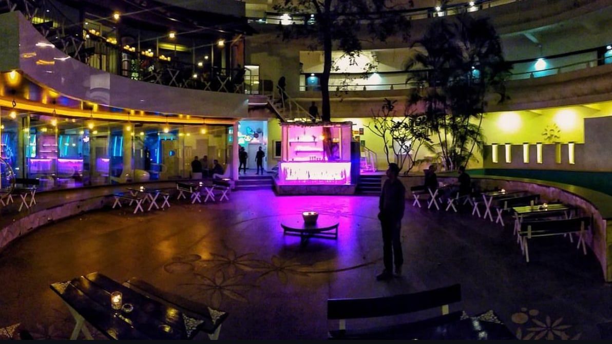 Courtyard dressed for a party under coloured lights
