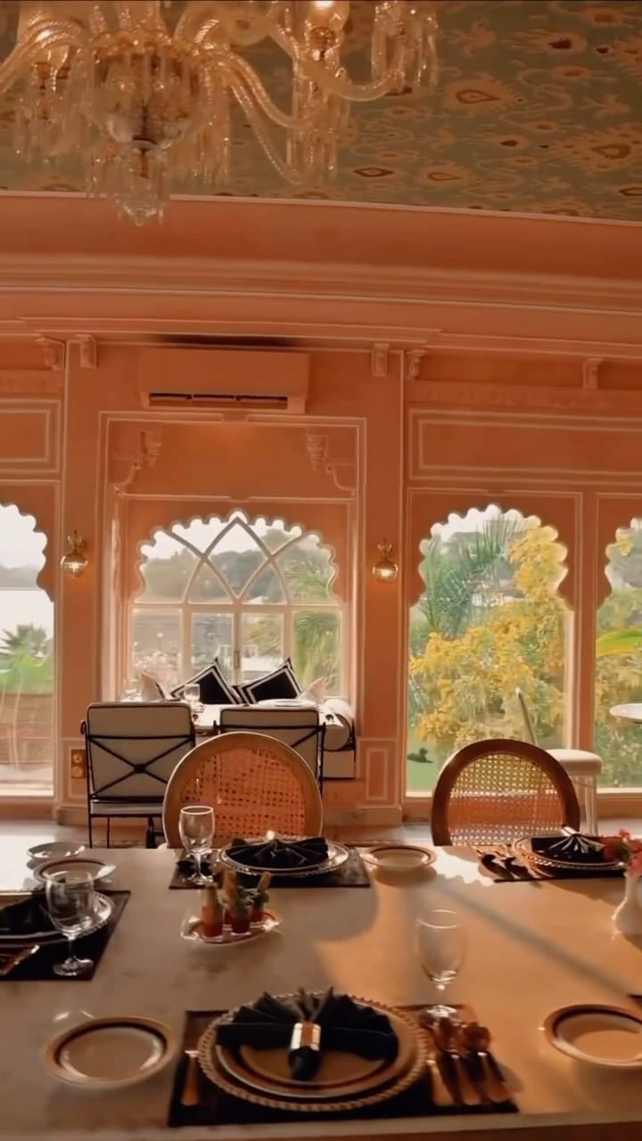 The Dari dining room with chandeliers and scalloped arched windows