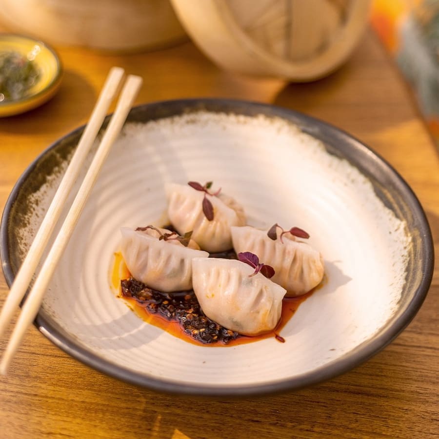 Dim sum with a drizzle of chilli oil and chopsticks
