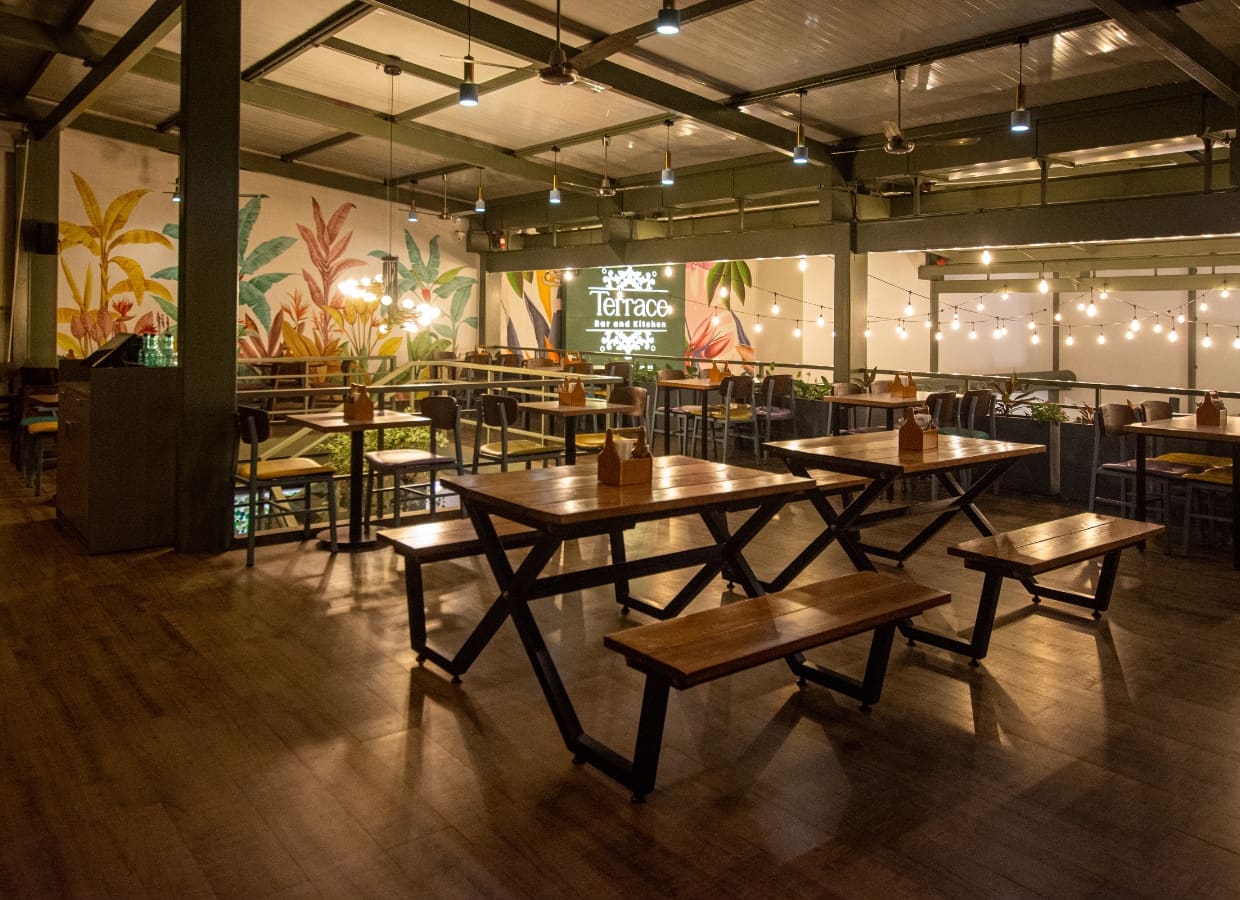Long communal tables under warm pendant lights