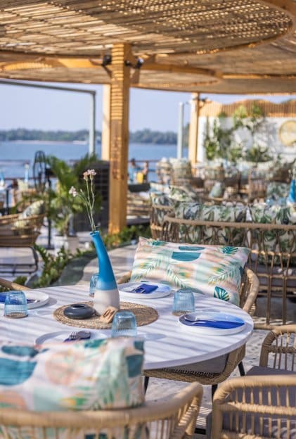 A table set by the sea under the rattan shade
