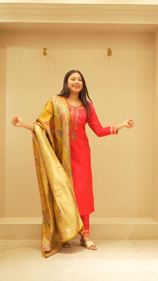 Red kurta and a Banarasi-style dupatta, arms outstretched