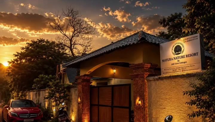 The resort's lit entrance gate and reception at sunset