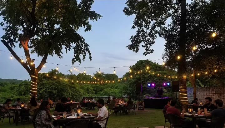 Garden tables lit up after sunset