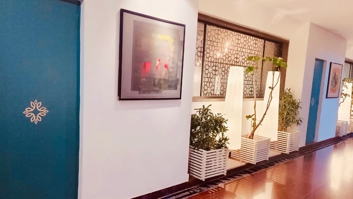 Bright hotel lobby with a lattice chair and planters