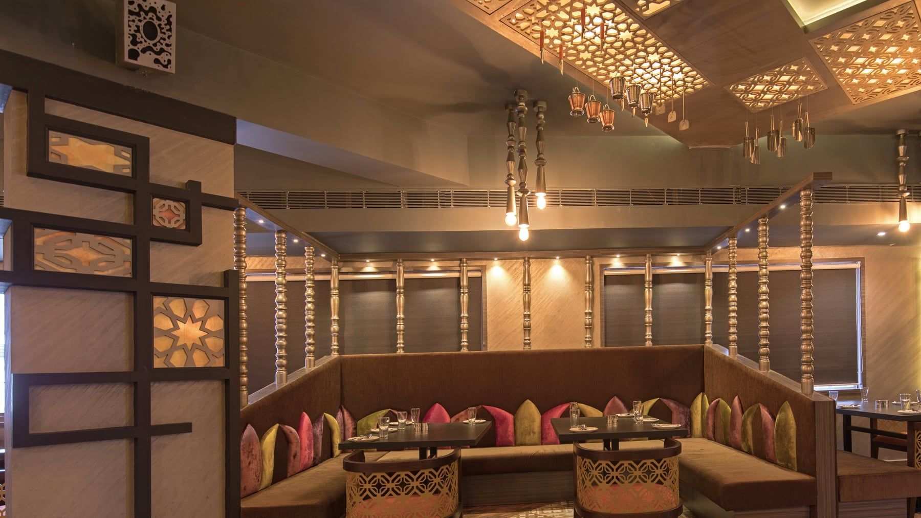 The Masala Room's carved jaali booths under brass lanterns
