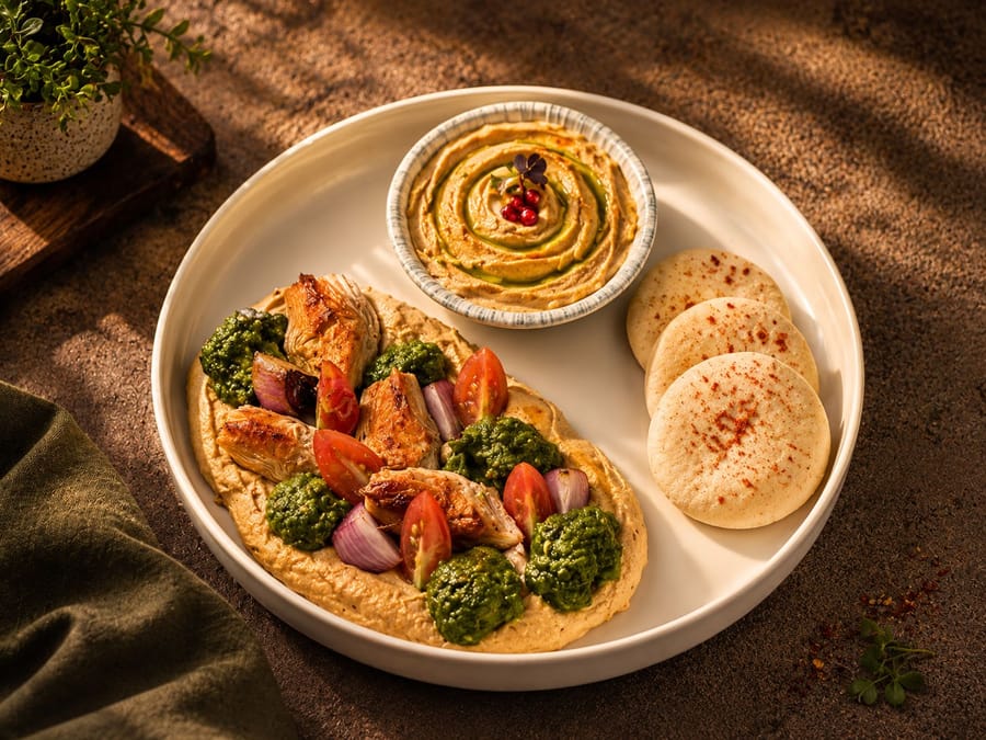 A mezze platter of dips, breads and greens