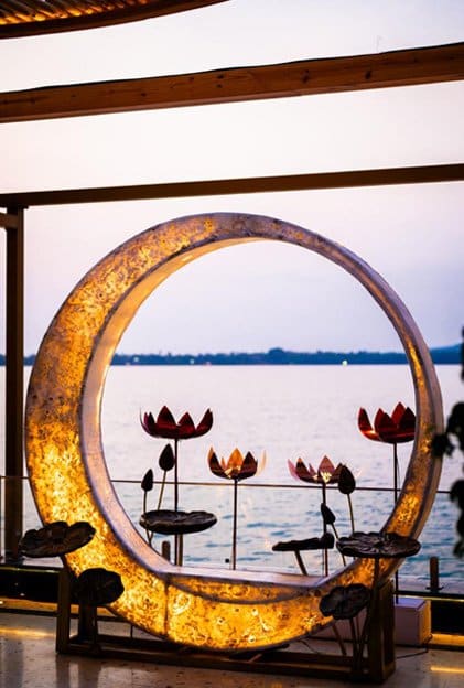 The illuminated moon ring sculpture facing the sea