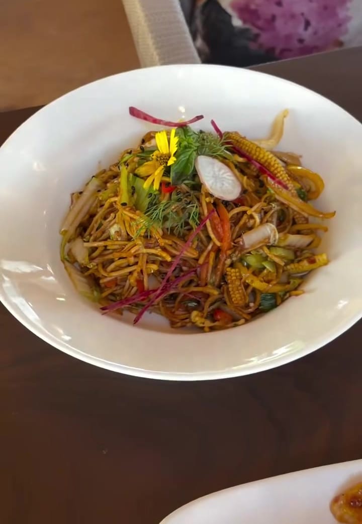 Noodles, tossed and garnished