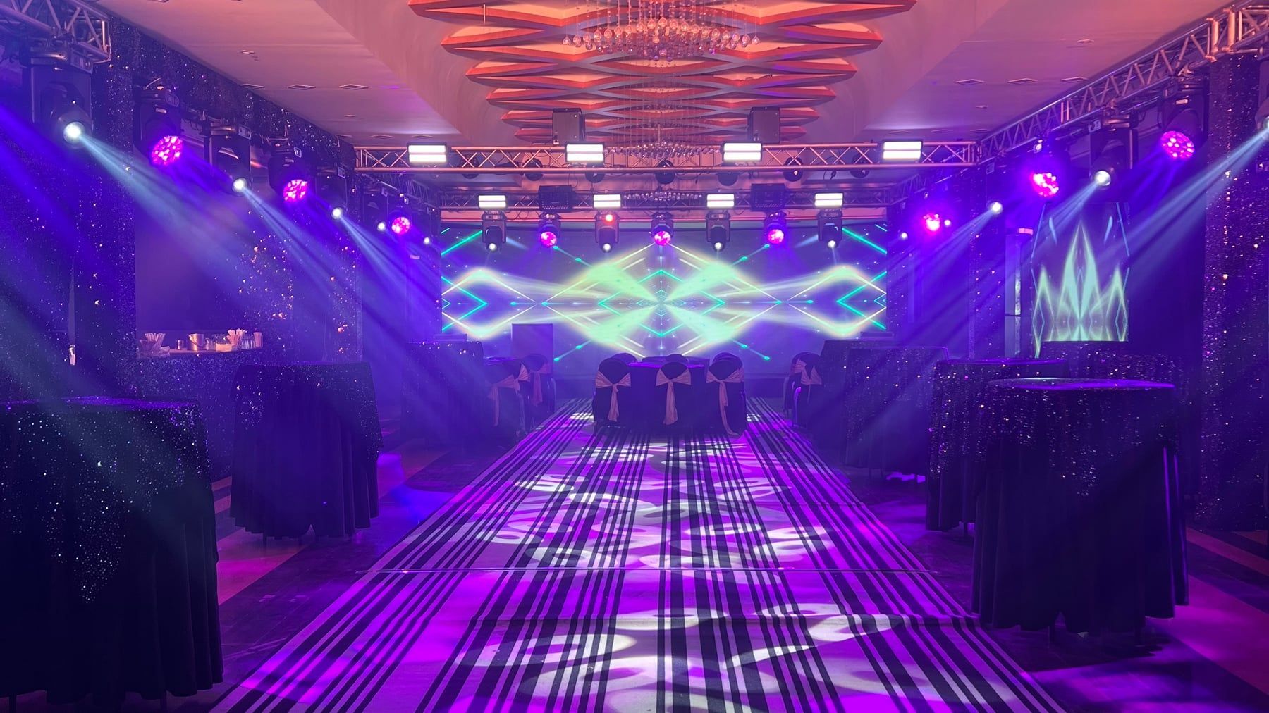 OMG Lounge dance floor washed in violet stage lights