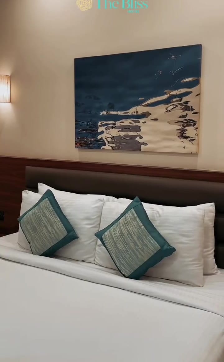 Teal cushions under an ocean painting