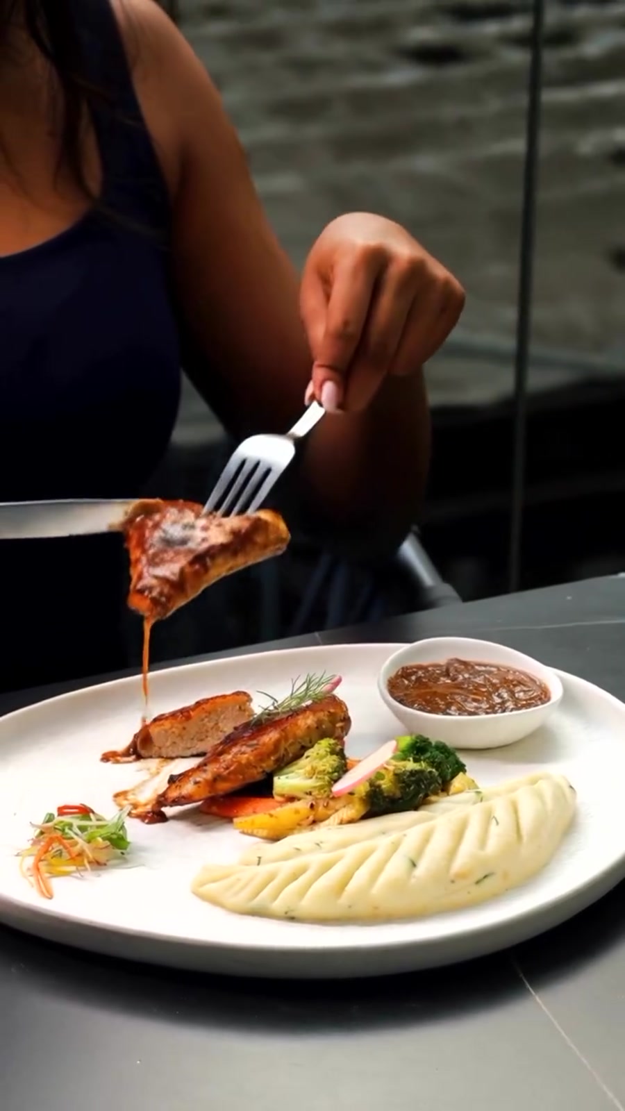 A grilled platter with mash and roasted vegetables