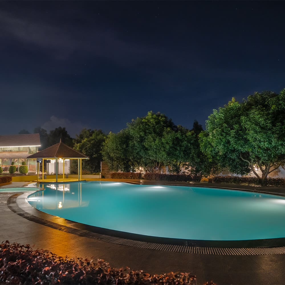The pool glowing blue at night