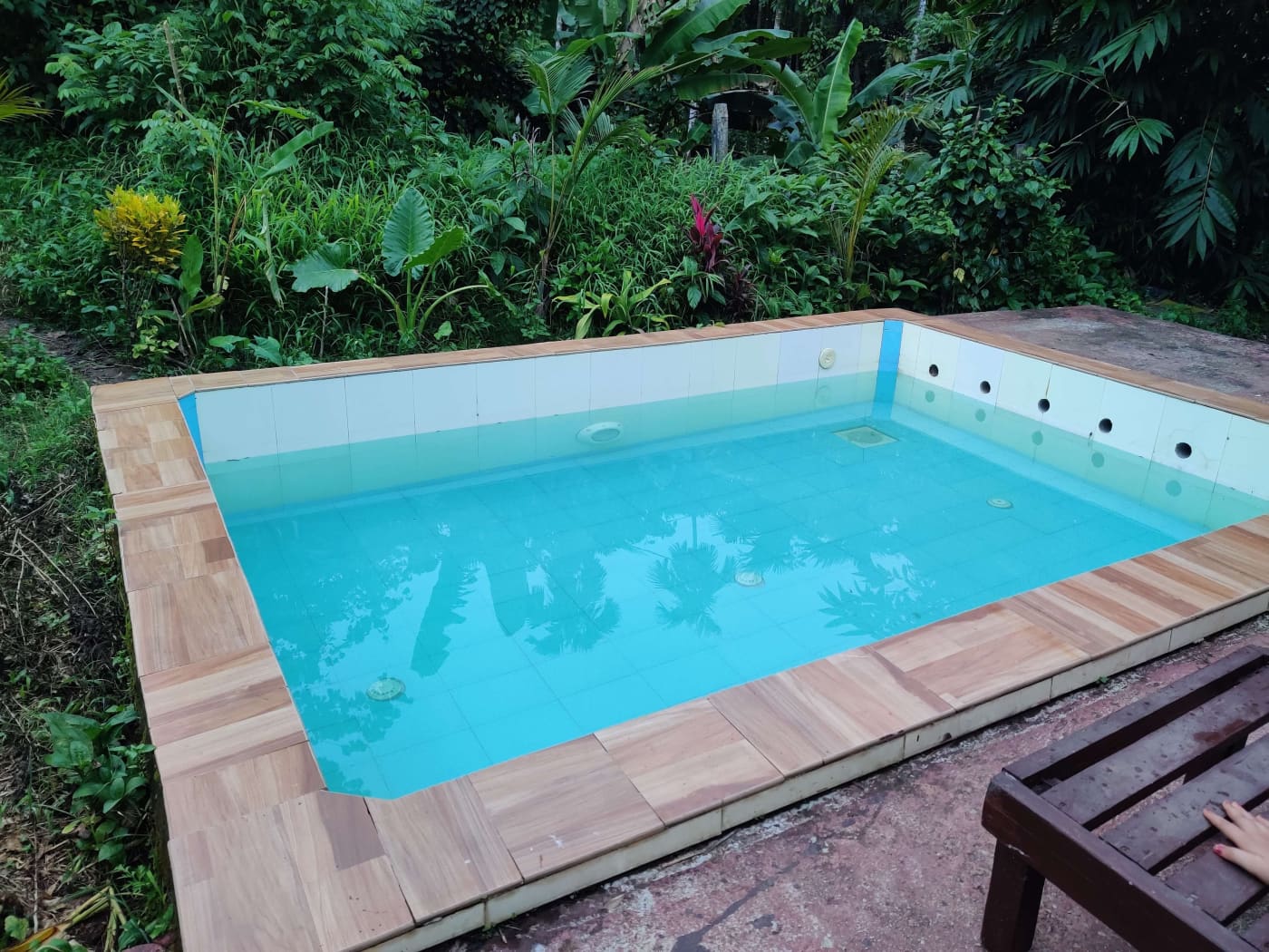 The swimming pool with a wooden deck
