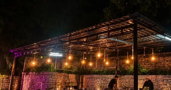 The Mayura Nature Restaurant at night under string lights