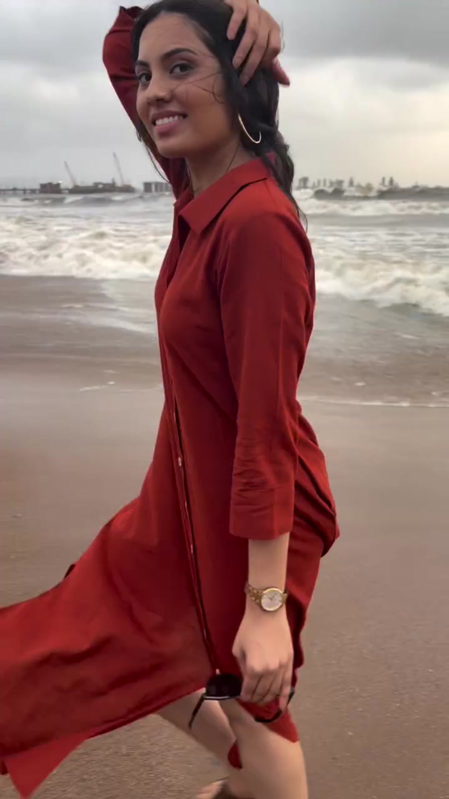 A rust shirt dress worn buttoned up on the beach