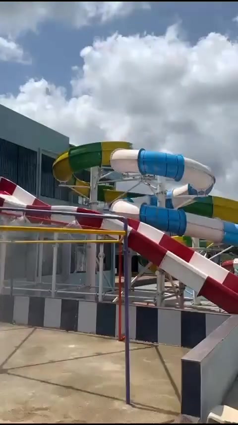 Red and white tube slides twisting down to the pool