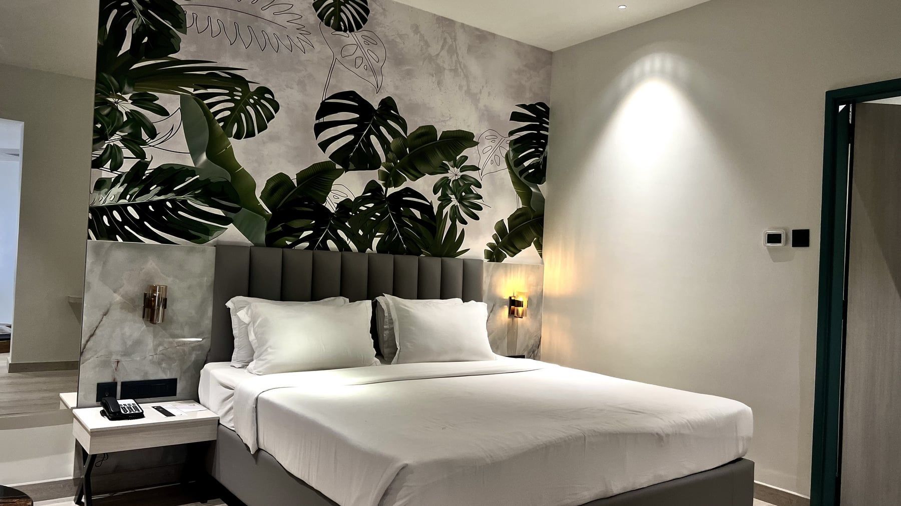 Luxury room with a monstera mural