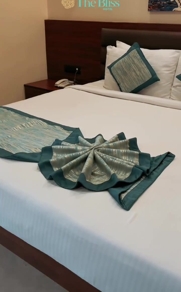 Towel folded into a fan on the bed