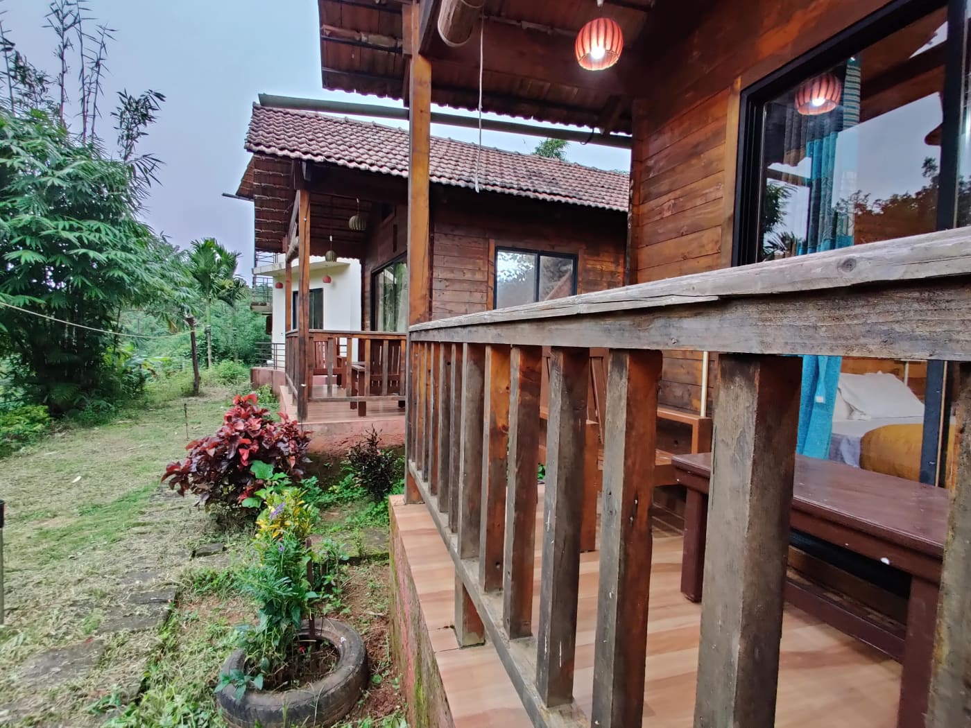 The verandah of a wooden cottage with a tiled roof